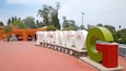 A large sign reading "ZACINGO Zoologico" with a red and green structure nearby.