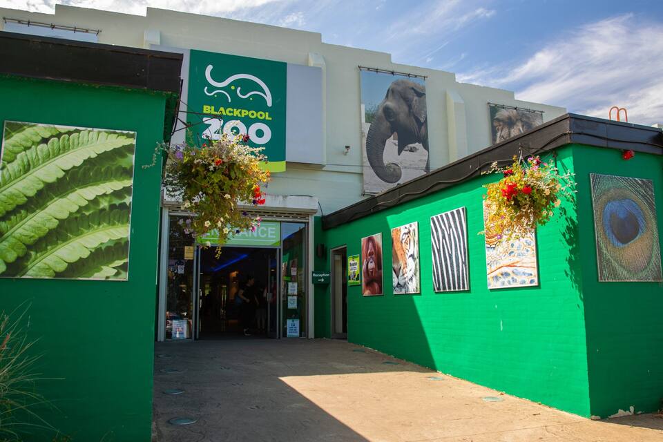 A green building with a sign reading "Blackpool Zoo".
