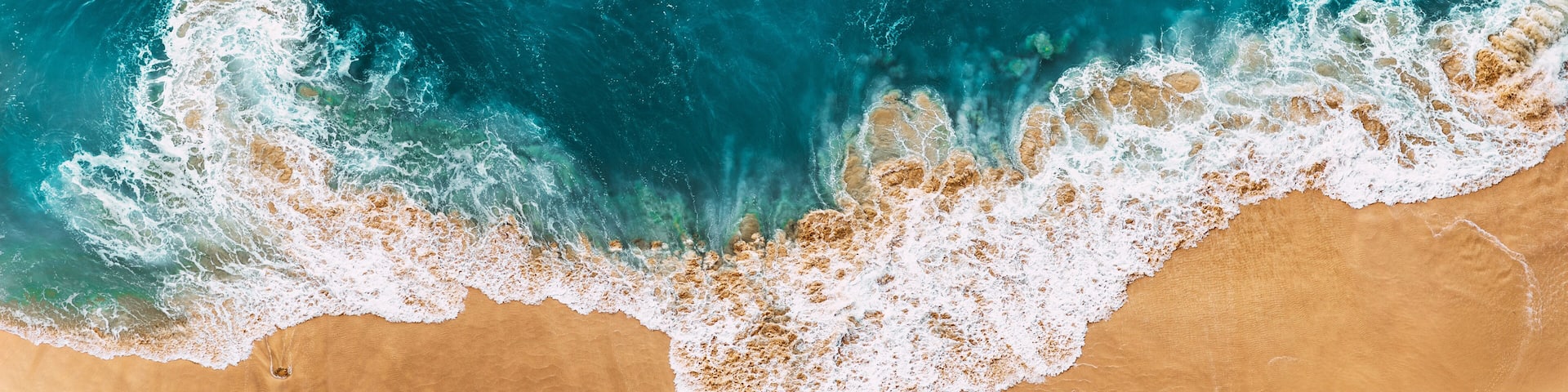 Relaxing aerial beach scene, summer vacation holiday template banner. Waves surf with amazing blue ocean lagoon, sea shore, coastline. Sandy beach, panorama. Panoramic view of the sandy beach.