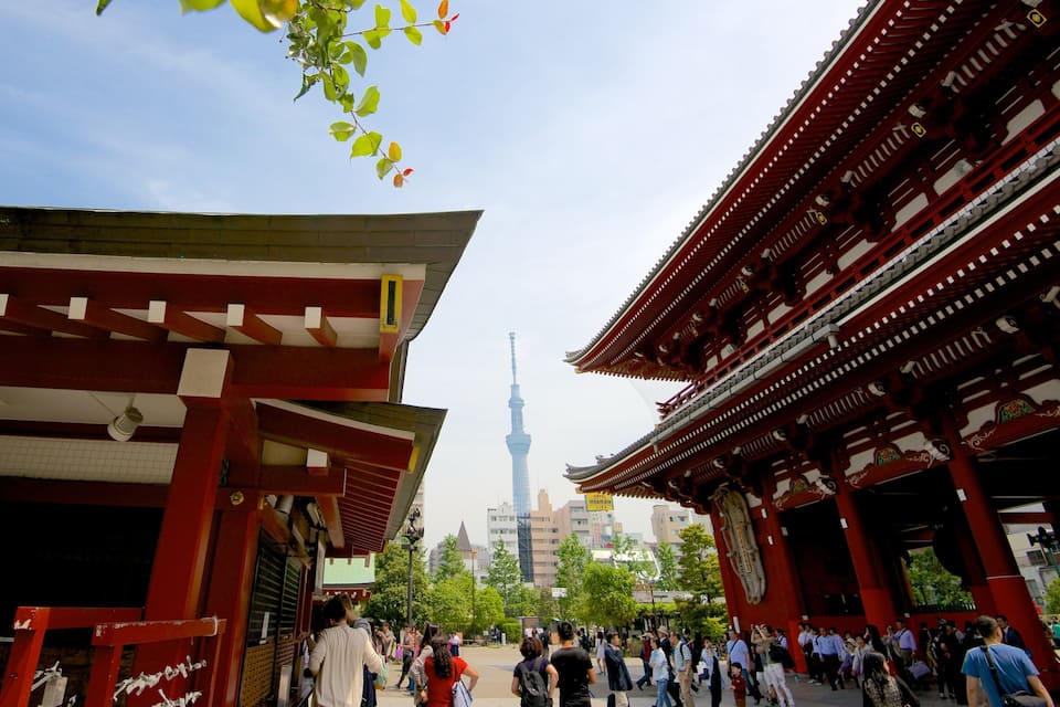 A traditional Japanese building with red pillars and a sign in Japanese.
