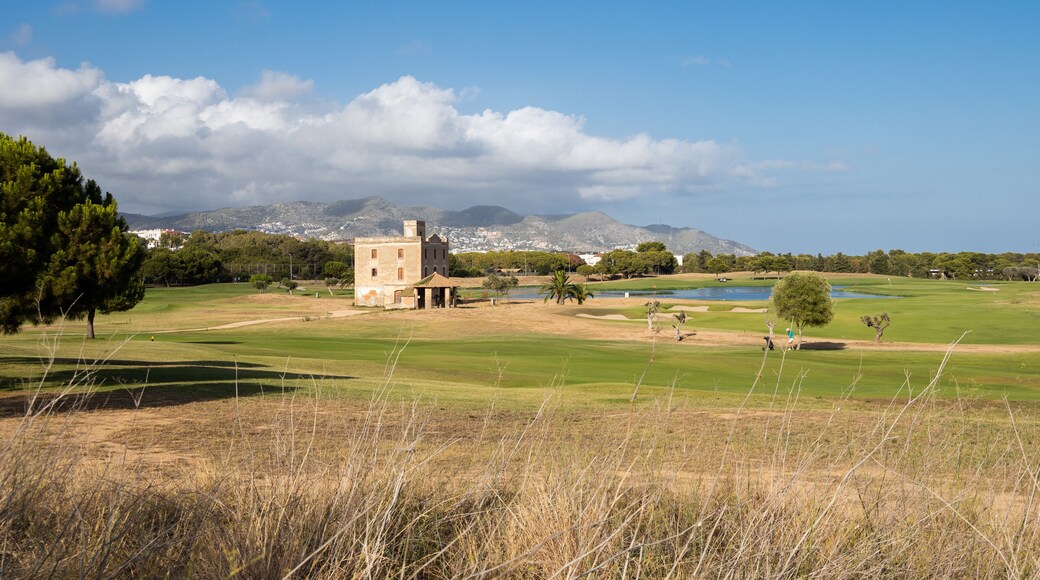 Golf club Terramar in Sitges at sunny day, playing golf on the green grass with water pond, open and green golf course
