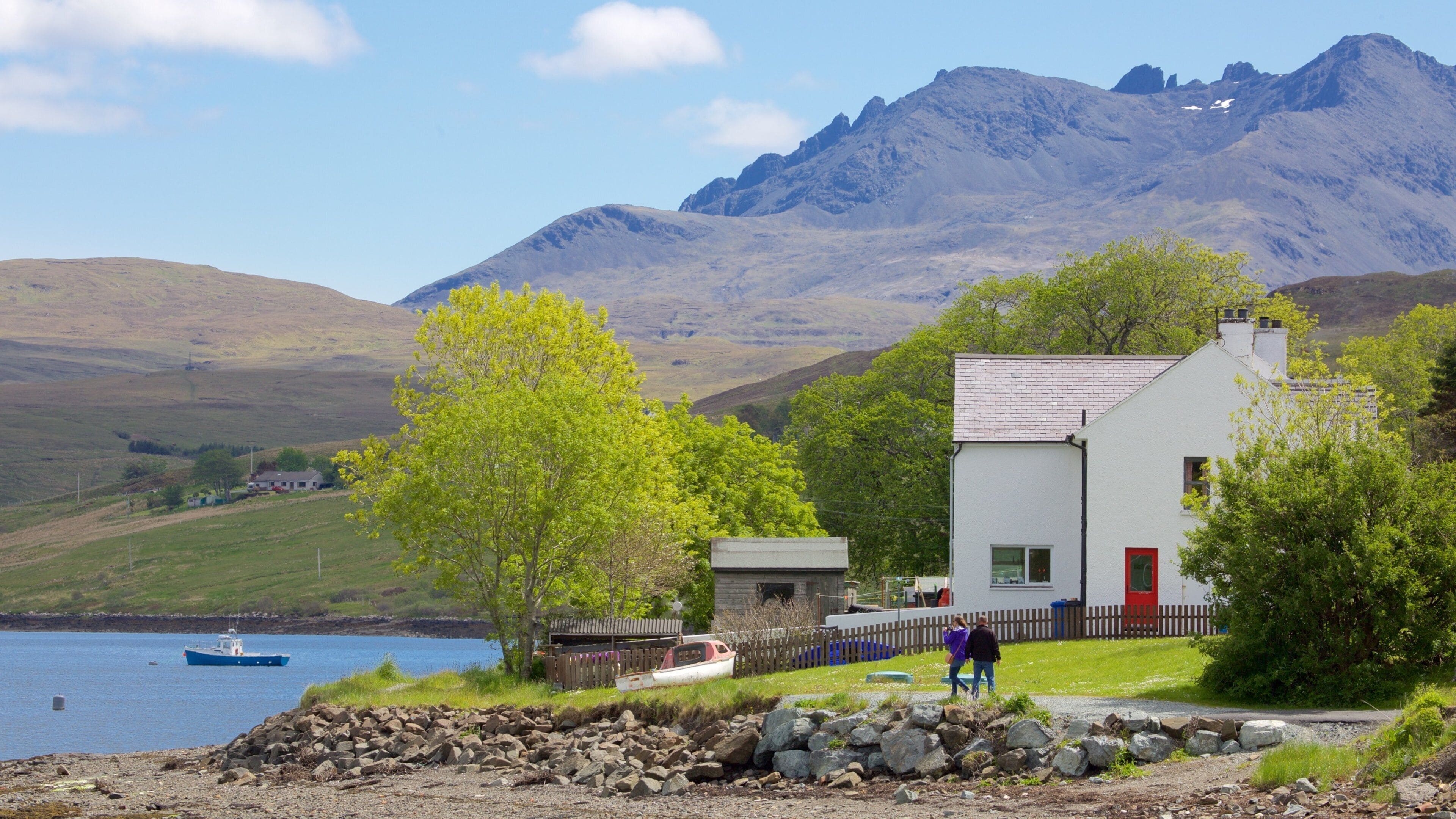 Talisker Distillery showing a lake or waterhole, a house and mountains