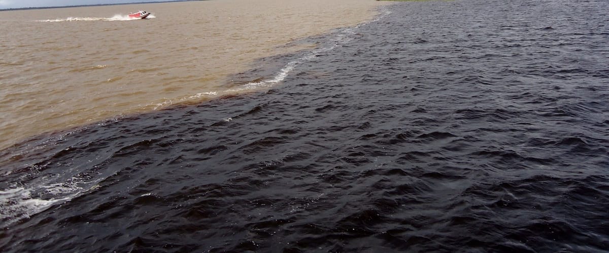 In Manaus, Brazil, the Amazon River and the Rio Negro merge. The Amazon is the sandy colored water, and the Rio Negro is the dark colored water. For almost 4 miles the two rivers run side by side without mixing. It's one of those things you almost have to see to believe. I saw it with my own two blue eyes, so I do believe!!