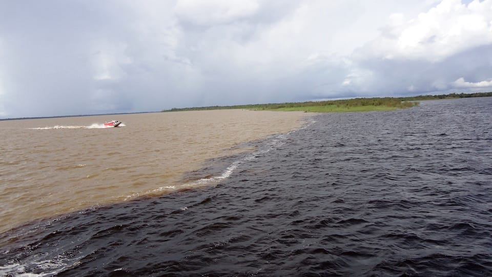 In Manaus, Brazil, the Amazon River and the Rio Negro merge. The Amazon is the sandy colored water, and the Rio Negro is the dark colored water. For almost 4 miles the two rivers run side by side without mixing. It's one of those things you almost have to see to believe. I saw it with my own two blue eyes, so I do believe!!