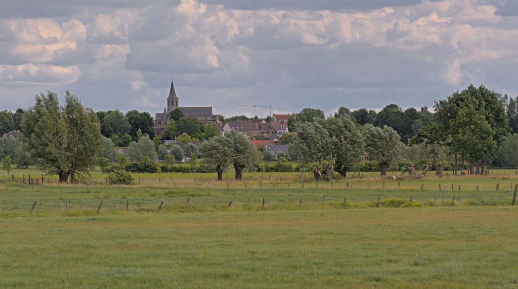 Farm landscae with lush green spring meadows and Gavere village and church. Flanders, Belgium