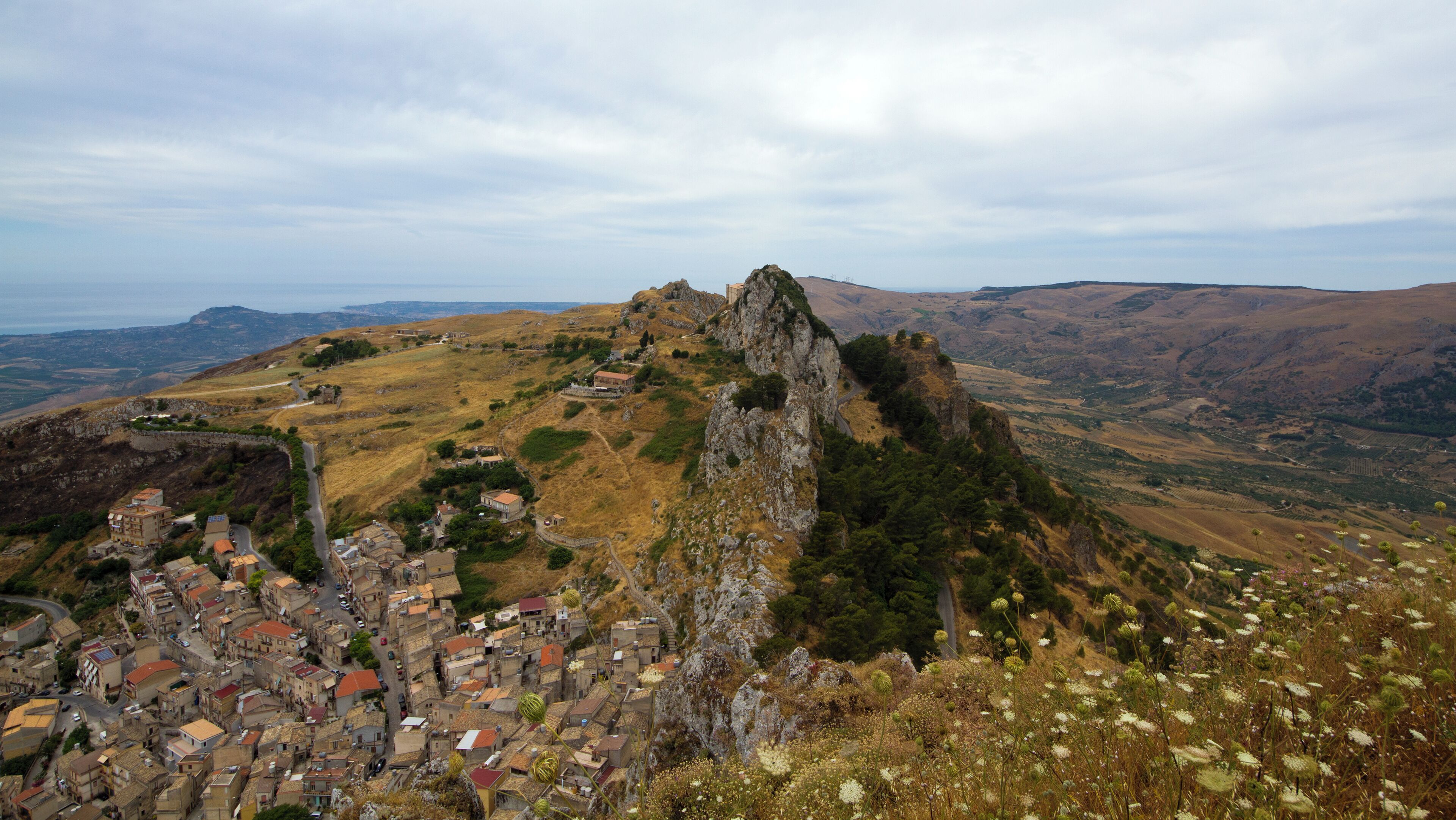 A mountainous landscape with a village nestled at its base.