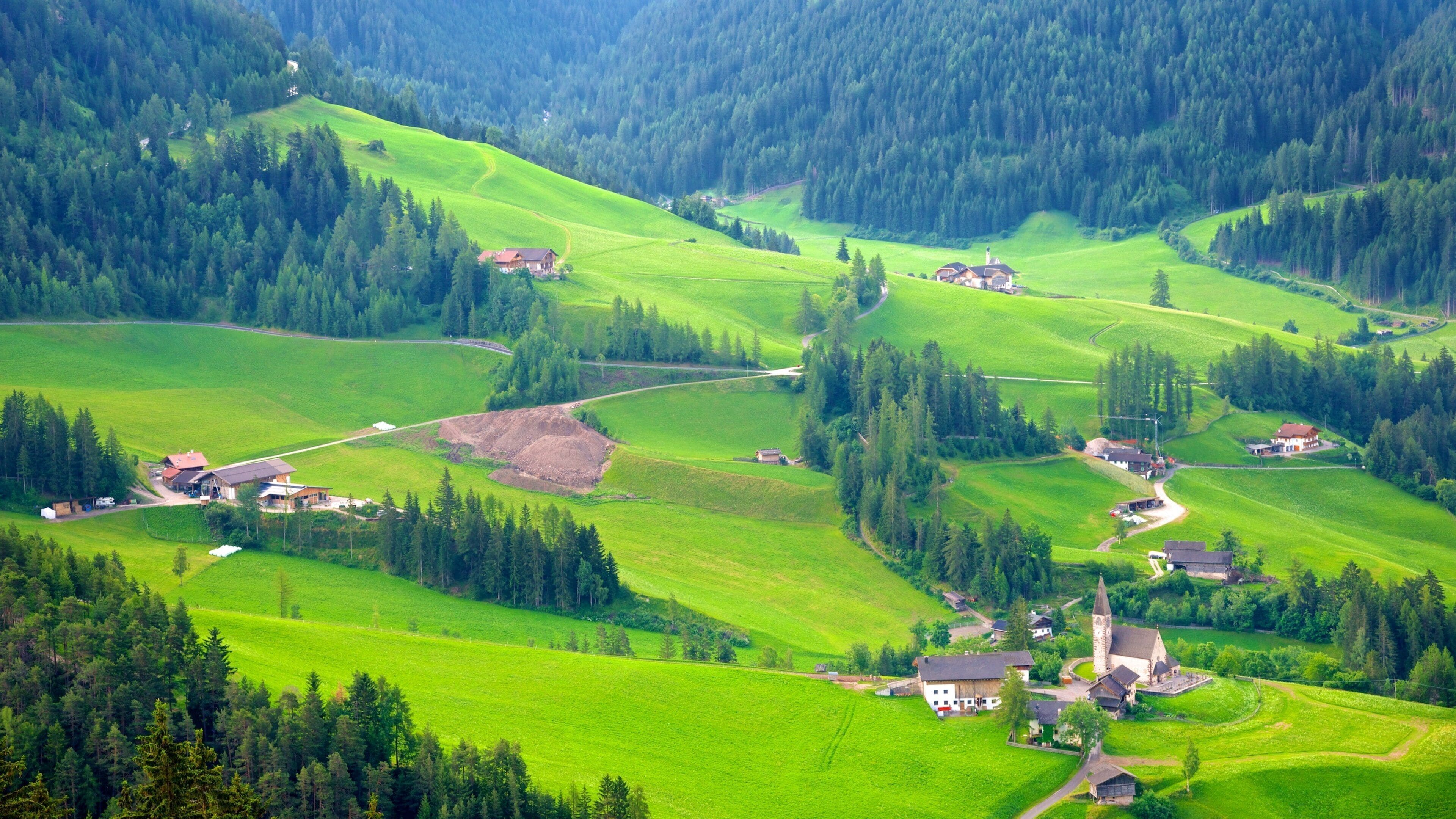 Funes som viser åkre, liten by eller landsby og rolig landskap