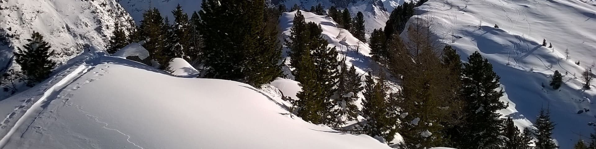 A snow-covered mountain landscape with a clear sky.