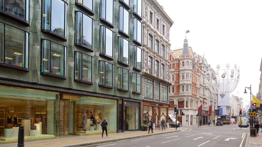 A street with modern and historic buildings, including a Mulberry store and a Baily store.