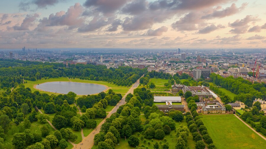 Beautiful aerial view of the Hyde park in London, UK. Magical sunset view over the park with London skyline on the horizon.