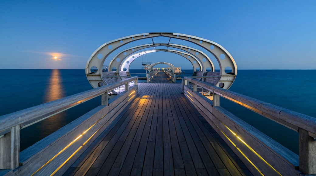 Illuminated pier on the Baltic Sea resort of Kellenhusen after sunset. View of Baltic sea resort Kellenhusen with its famous pier, Schleswig-Holstein, Germany.