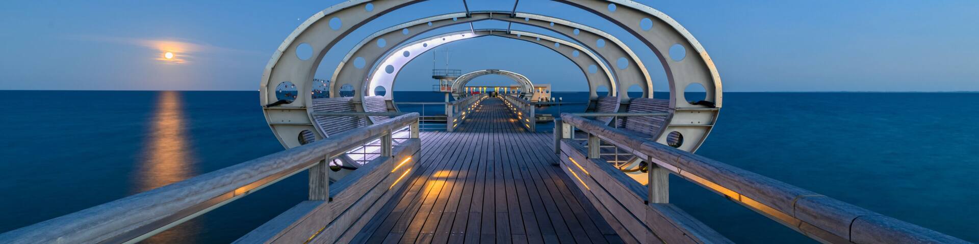 Illuminated pier on the Baltic Sea resort of Kellenhusen after sunset. View of Baltic sea resort Kellenhusen with its famous pier, Schleswig-Holstein, Germany.