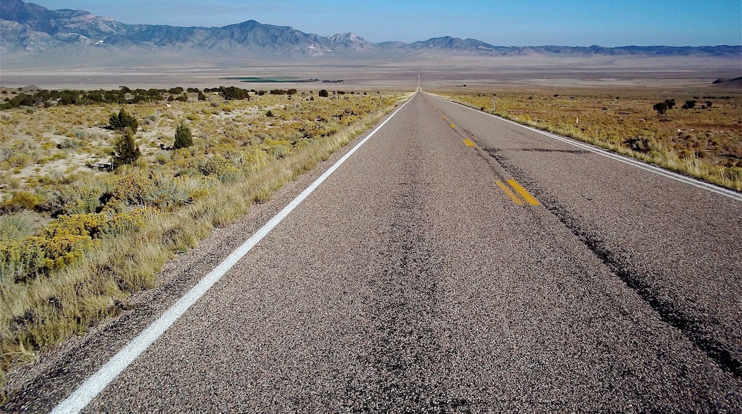 Driving across the loneliest road in America. You can go straight as far as you can see and then you hit a mountain range. This will happen several times going west across Nevada. #Perspectives