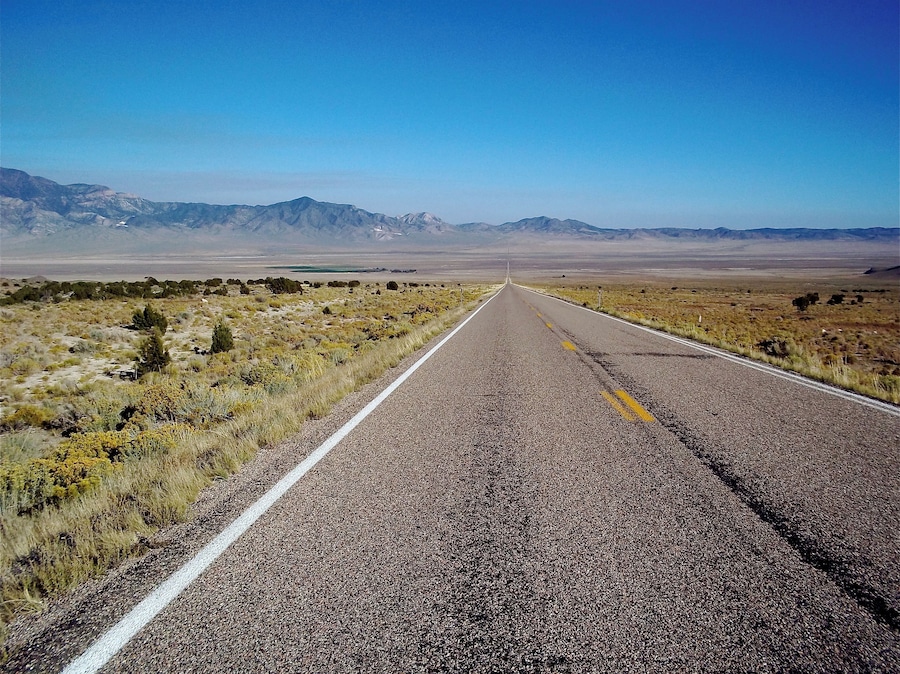 Driving across the loneliest road in America. You can go straight as far as you can see and then you hit a mountain range. This will happen several times going west across Nevada. #Perspectives