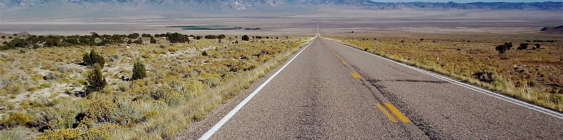 Driving across the loneliest road in America. You can go straight as far as you can see and then you hit a mountain range. This will happen several times going west across Nevada. #Perspectives