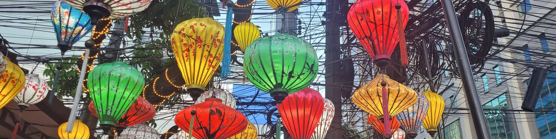 A street decorated with colorful lanterns.
