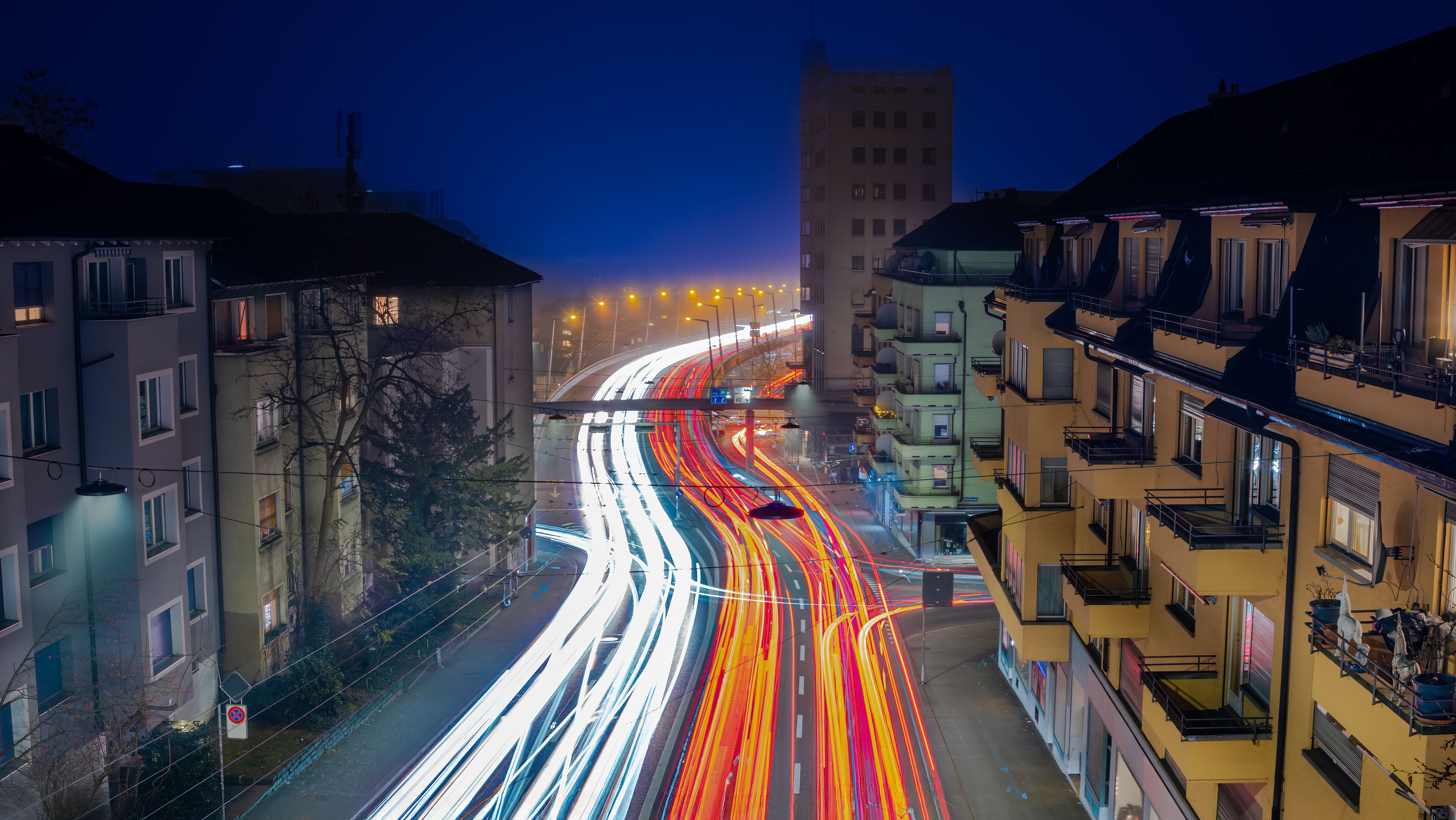 Dynamic Night Traffic and light trails at City Intersection in Zurich, Switzerland
