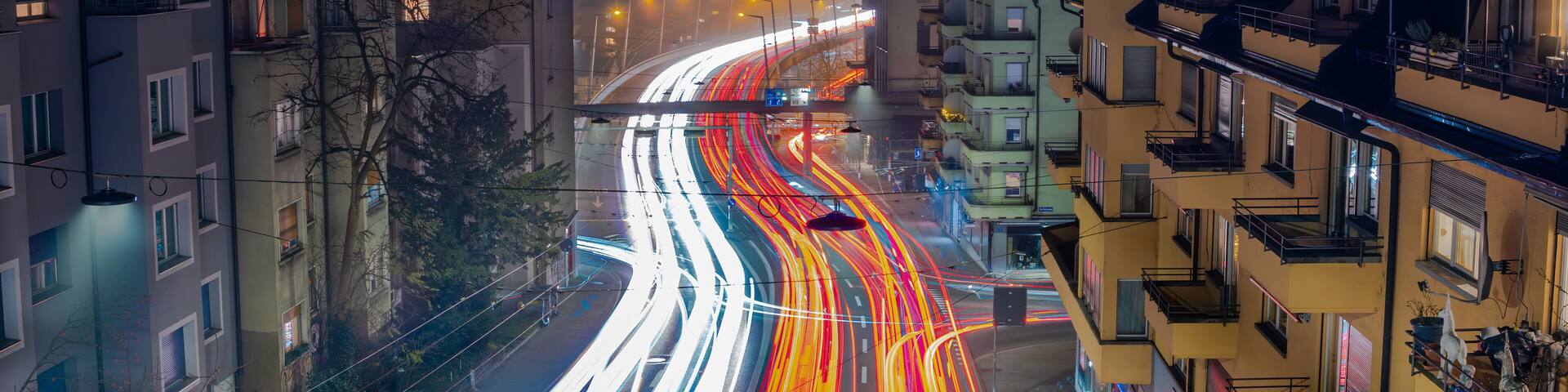 Dynamic Night Traffic and light trails at City Intersection in Zurich, Switzerland