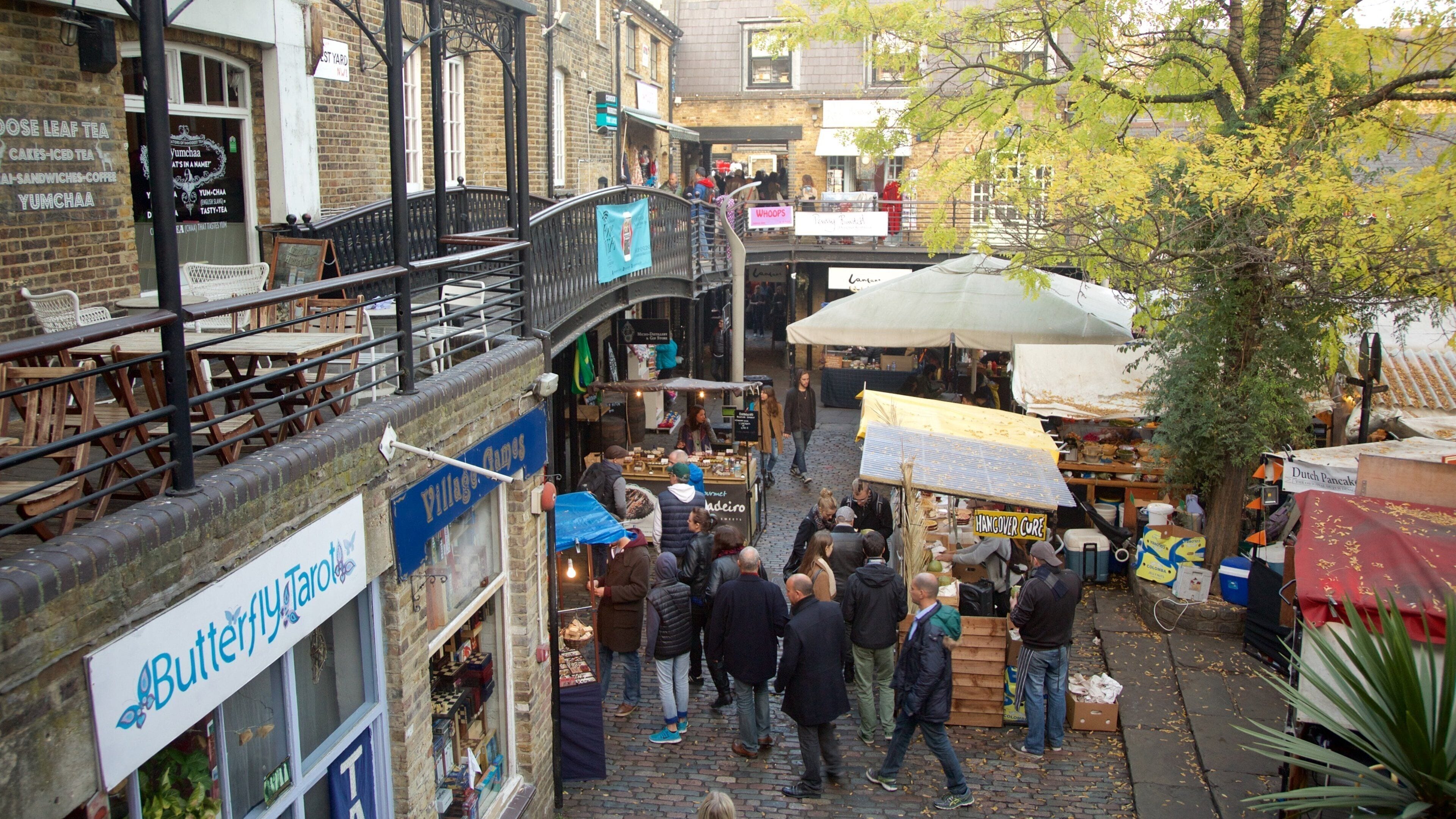 A bustling outdoor market with vendors and shoppers.