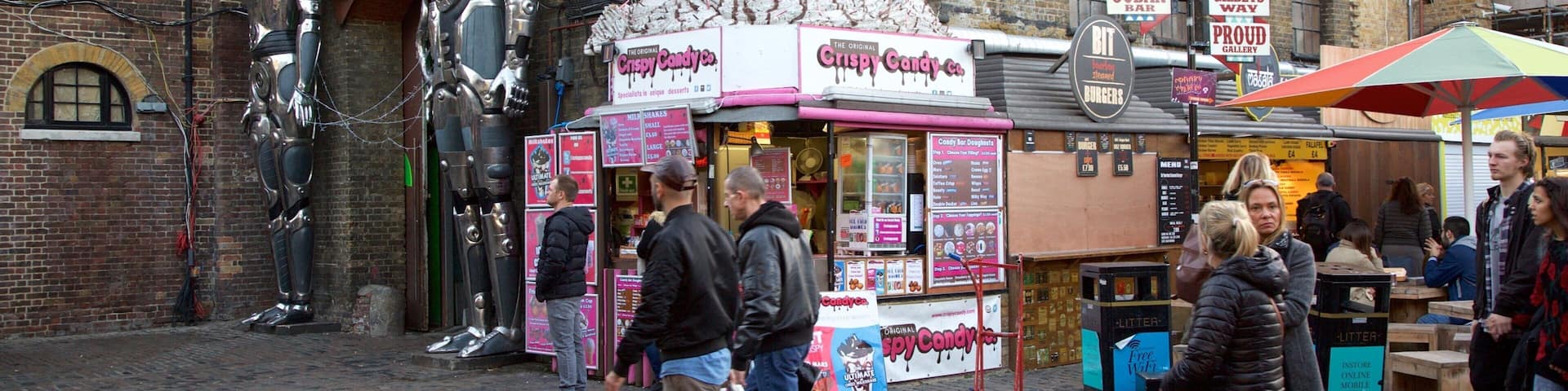 Camden Markets showing signage, markets and a statue or sculpture