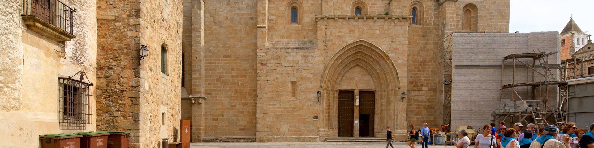 A historic stone building with a large arched entrance and a bell tower.