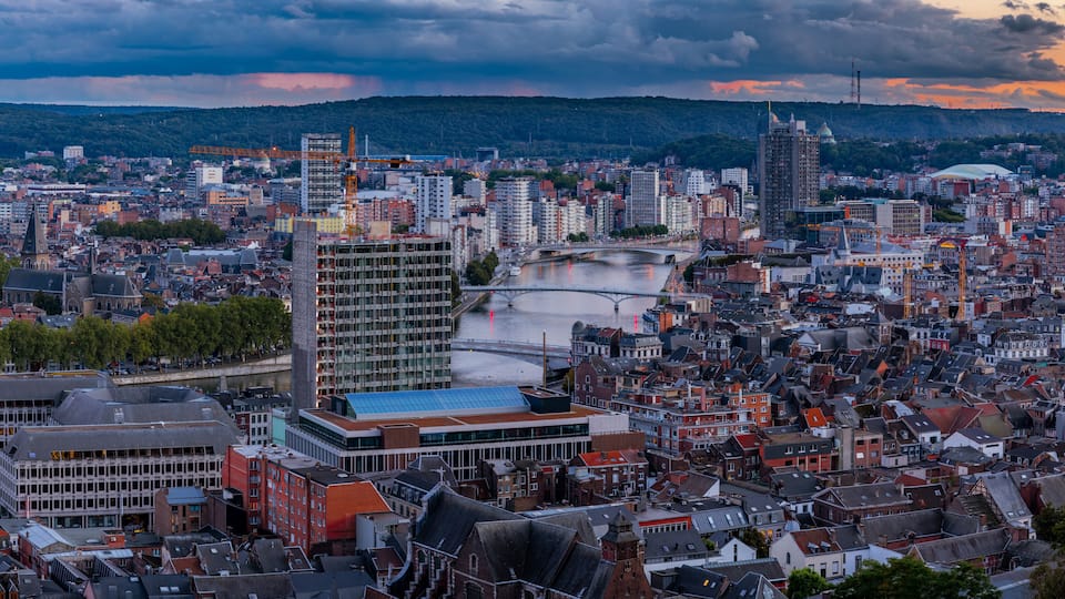 HDR Panorama with an amazing view over the Belgium city of Liege during a colourful sunset and in the background a dramatic sky with clouds full of heavy rain.