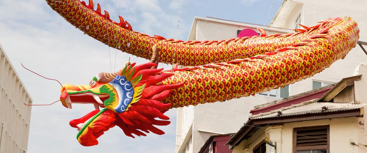 A large dragon float in a street.