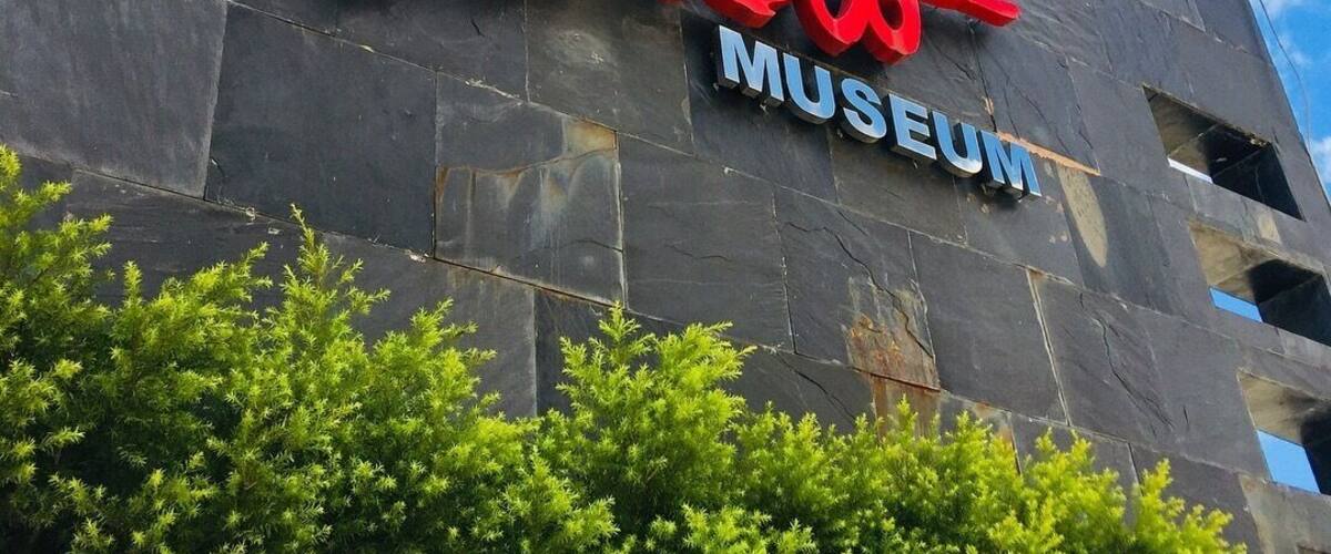 A building with a sign that reads "Benab Museum" in red and blue letters.