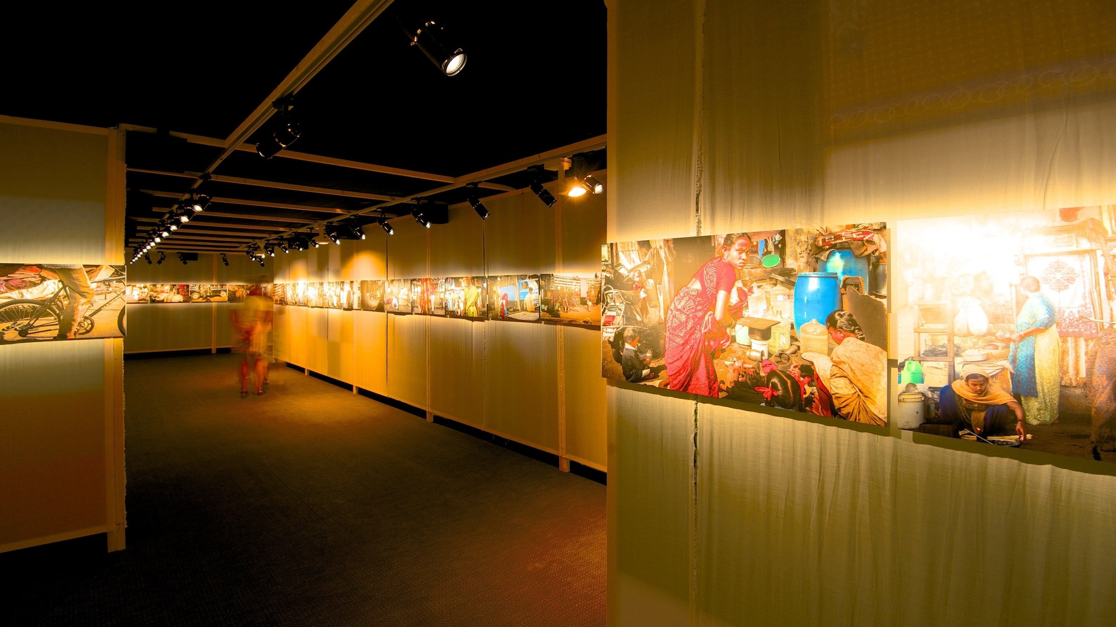 An indoor art gallery with illuminated wall displays.