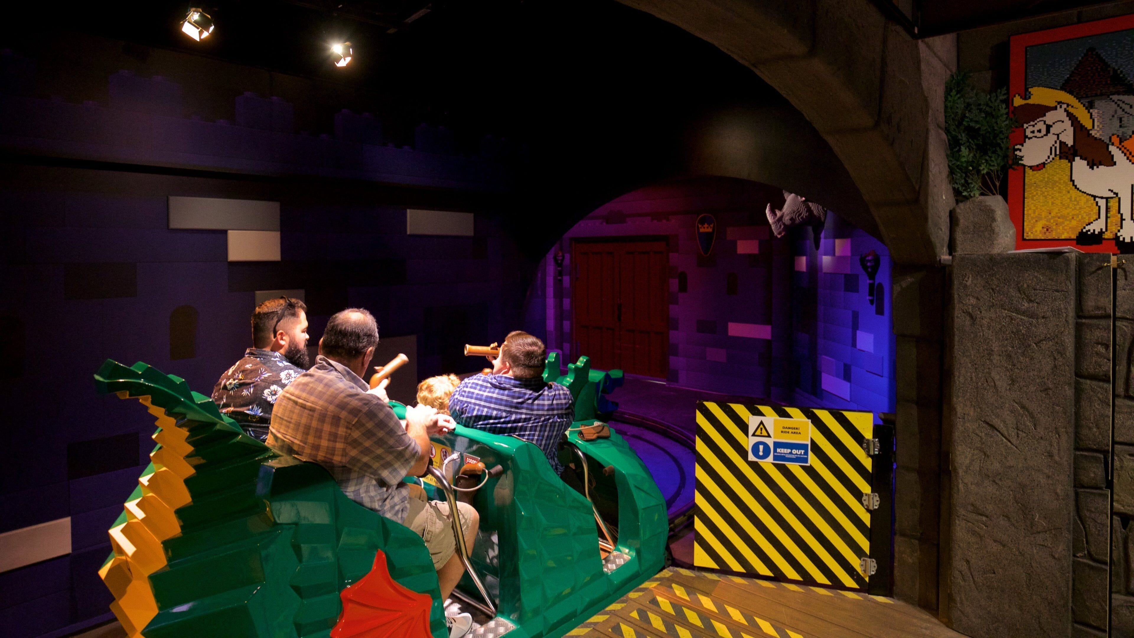 Legoland Discovery Center showing rides as well as a small group of people