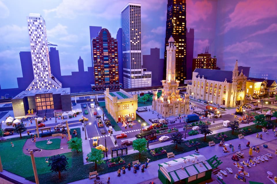 A detailed LEGO cityscape with various buildings, streets, and miniature figures.