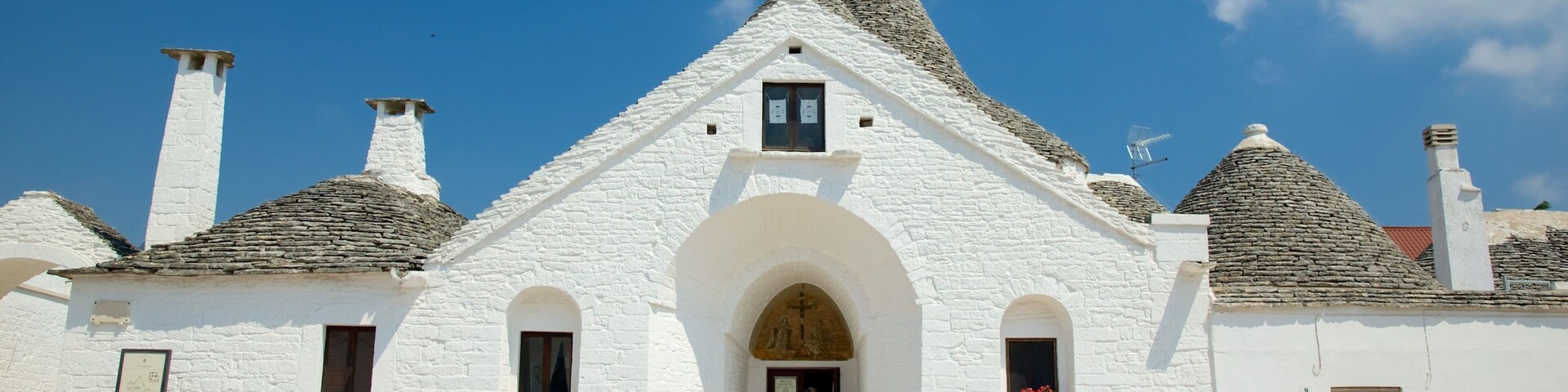 Trullo Sovrano que incluye arquitectura patrimonial y una ciudad