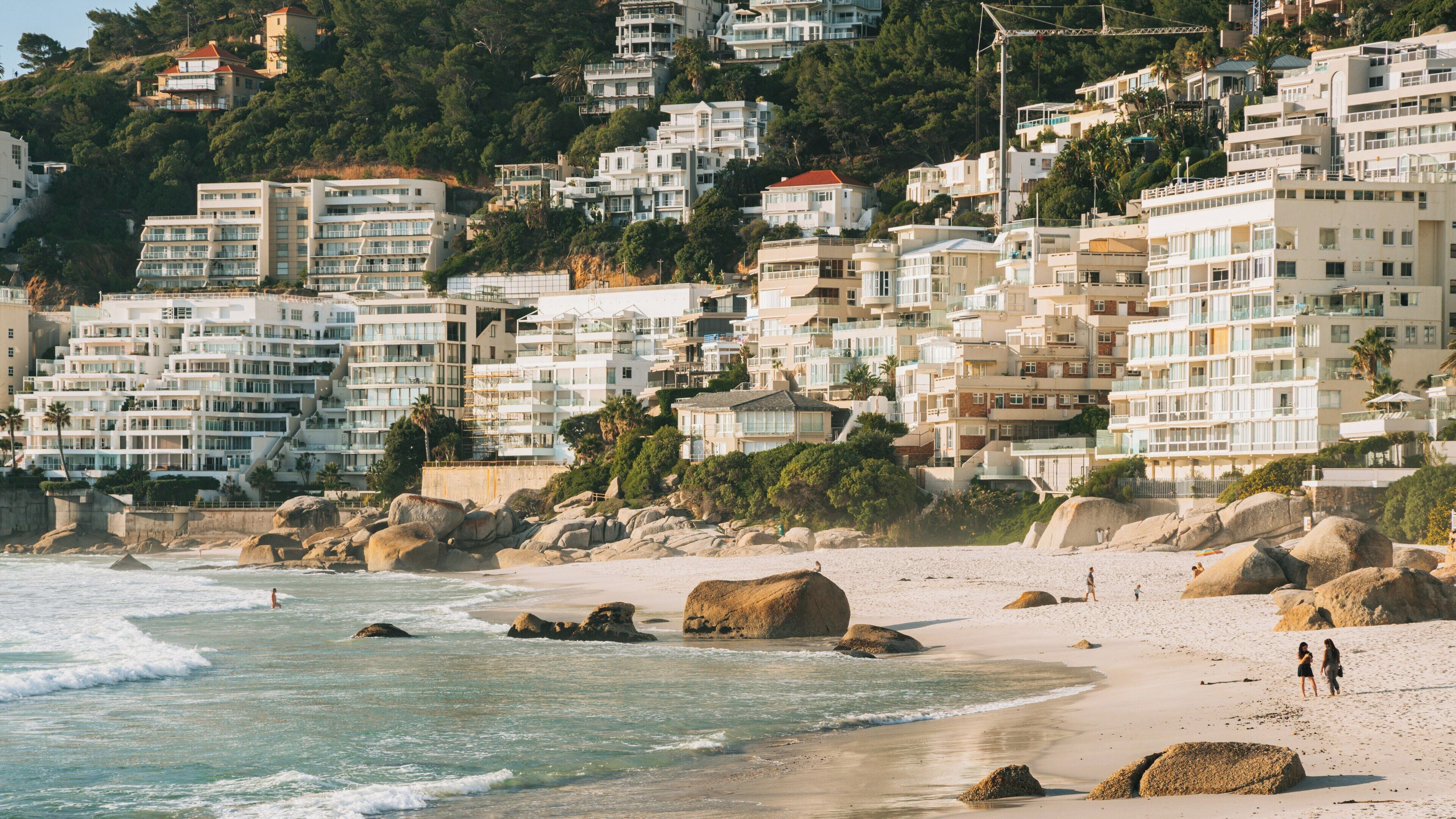 Clifton Bay Beach in Cape Town showcases luxury homes, golden sands, and tranquil waters, inviting visitors to enjoy the scenic beauty and relaxed atmosphere