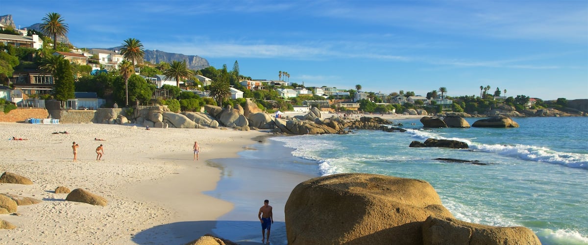 Clifton Bay Beach which includes rugged coastline, a sandy beach and a coastal town