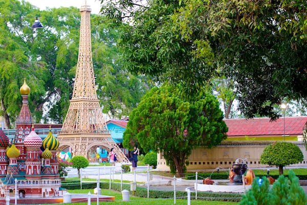 A model of the Eiffel Tower surrounded by trees and a fountain.