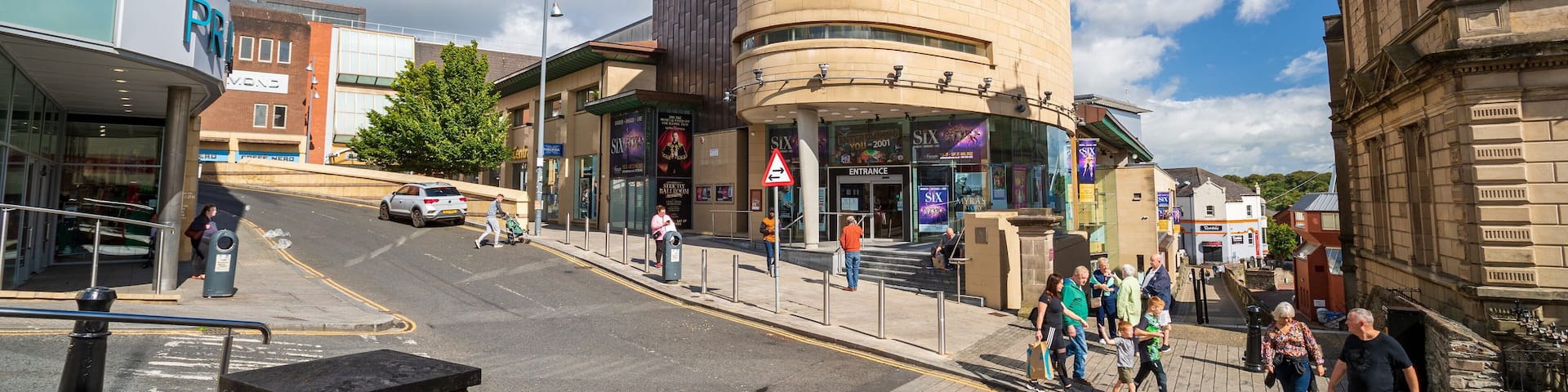 The Millennium Forum building with a curved entrance and a sign above it.