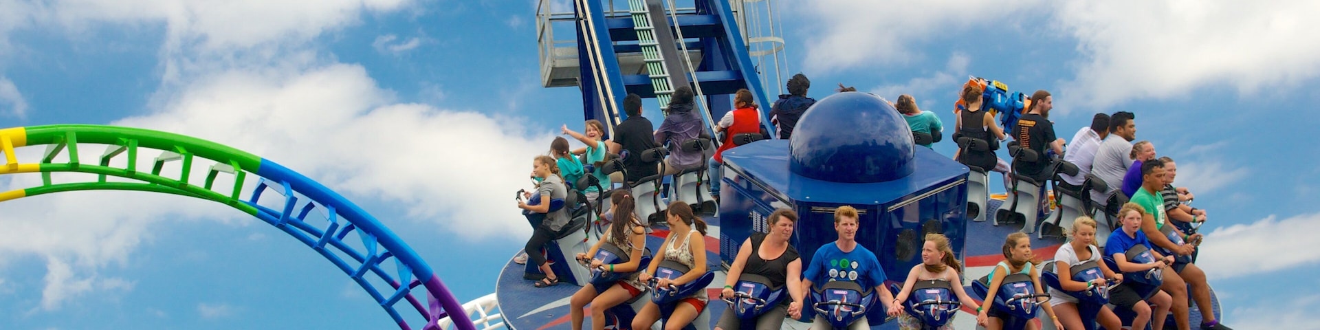 Rainbow\'s End showing rides as well as a large group of people