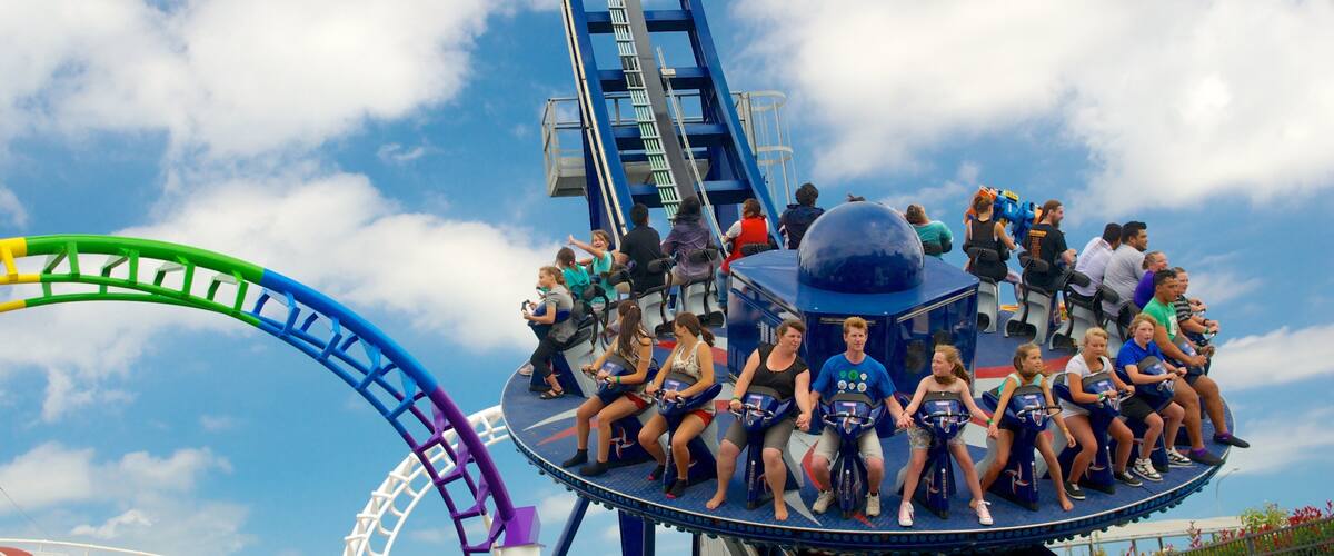 A roller coaster with a blue track and a large blue dome structure.