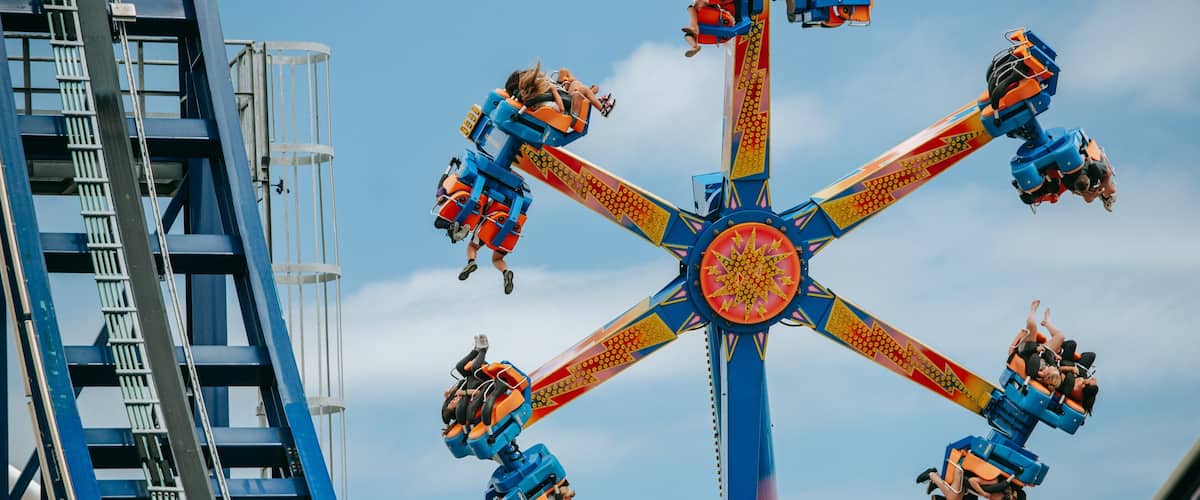 Rainbow\'s End featuring rides as well as a small group of people