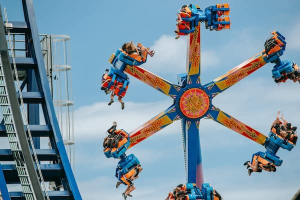 Rainbow\'s End featuring rides as well as a small group of people