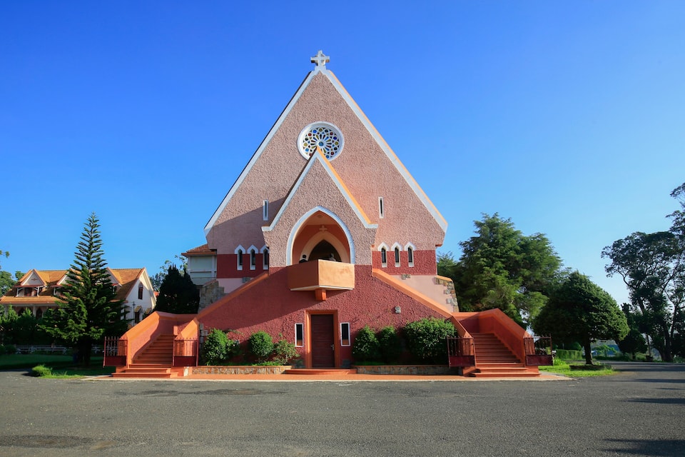 A church with a distinctive triangular roof and a circular window.