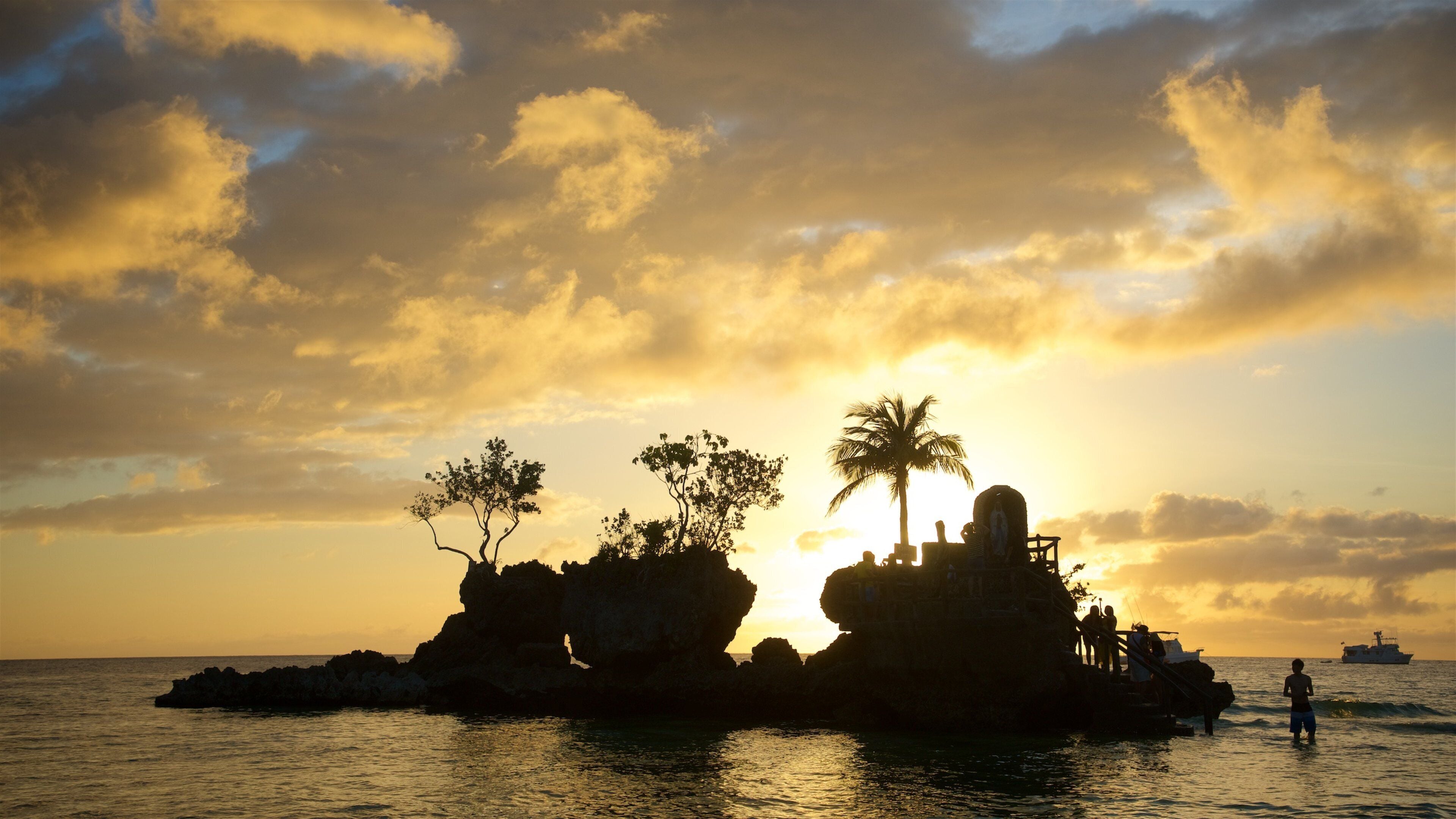 Willy\'s Rock featuring island images, tropical scenes and a sunset
