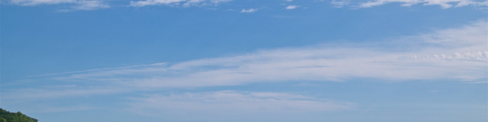 Pere Marquette Park Beach featuring a sandy beach and general coastal views as well as a small group of people