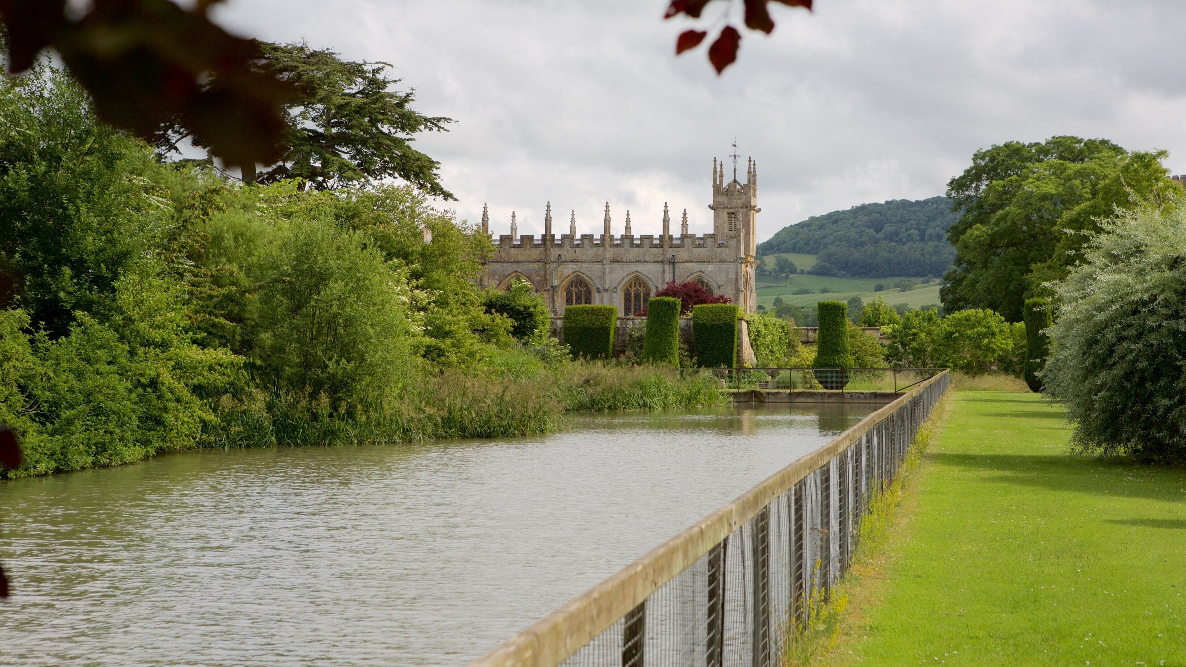 Sudeley Castle featuring a river or creek, a garden and chateau or palace