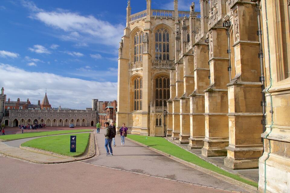 A historic building with large arched windows and statues.