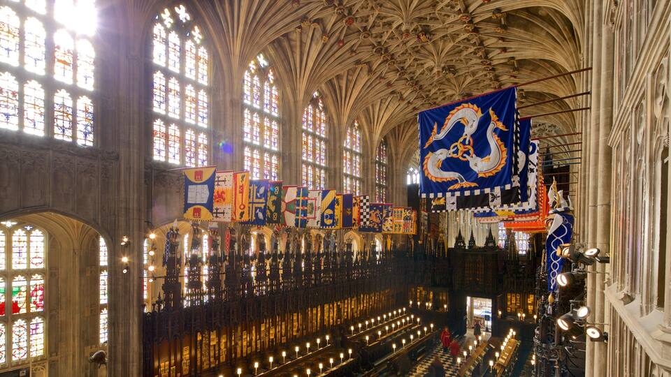 A cathedral interior with Gothic architecture, stained glass windows, and banners.