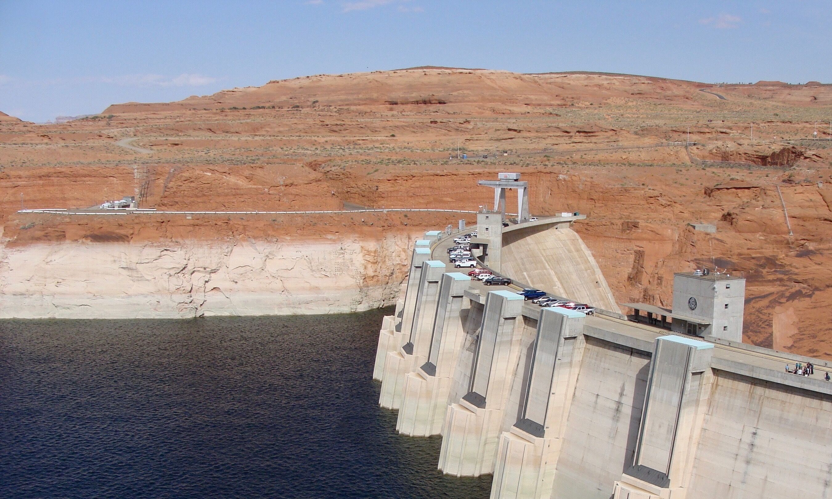 Glen Canyon Dam is a concrete arch dam on the Colorado River in northern Arizona in the United States, near the town of Page. The dam was built to provide hydroelectricity and flow regulation from the upper Colorado River Basin to the lower. Its reservoir is called Lake Powell, and is the second-largest artificial lake in the country, extending upriver well into Utah. The dam is named for Glen Canyon, a colorful series of gorges, most of which now lies under the reservoir.

#LikeALocal