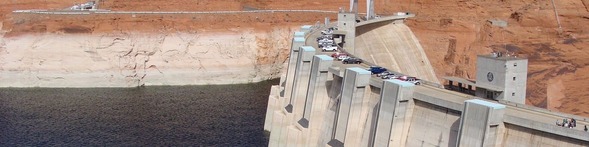 Glen Canyon Dam is a concrete arch dam on the Colorado River in northern Arizona in the United States, near the town of Page. The dam was built to provide hydroelectricity and flow regulation from the upper Colorado River Basin to the lower. Its reservoir is called Lake Powell, and is the second-largest artificial lake in the country, extending upriver well into Utah. The dam is named for Glen Canyon, a colorful series of gorges, most of which now lies under the reservoir.
#LikeALocal