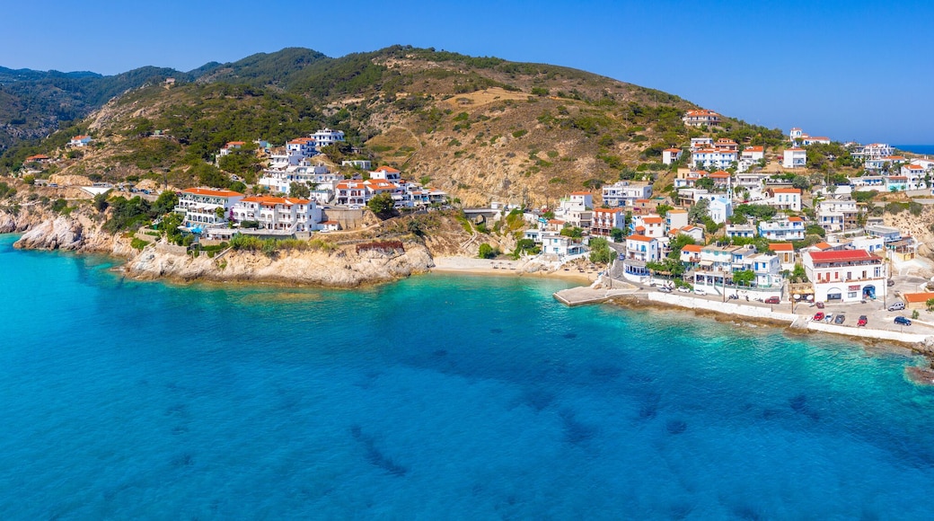Lovely greek fishing village of Armenistis in a quiet summer morning. Port with local beach in transparent clear water at Ikaria, Greece