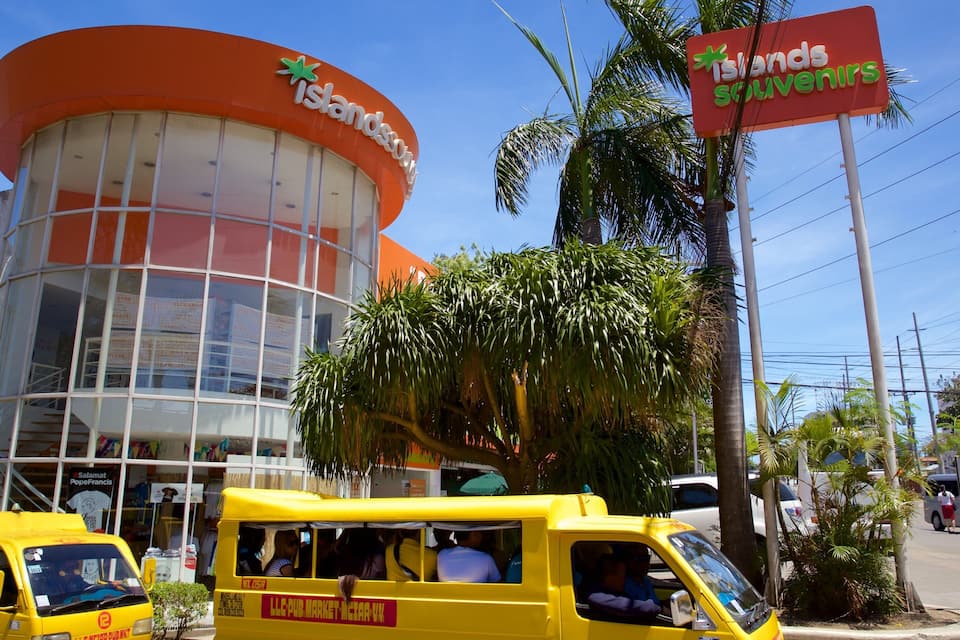 A building with a large orange sign reading "Islands Souvenirs" and a smaller sign for "Salamat PopeFrancis."